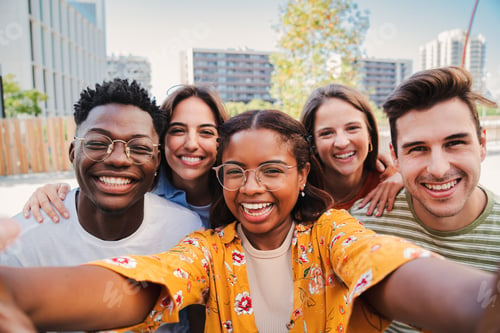 Preview: Group of multiracial young student people taking a selfie together looking at camera at the