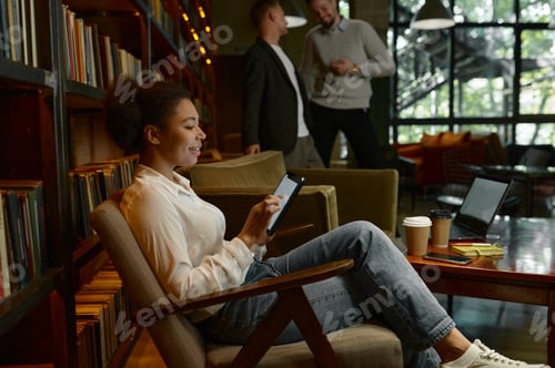 Preview: Coworking office open space concept, focus on employee working on tablet