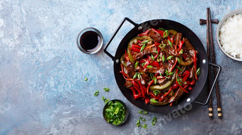 Preview: Beef and Vegetables Stir Fry in a pan and rice. Blue stone background. Copy space. Top view.