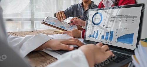 Preview: Business People Meeting using laptop computer,calculator,notebook,stock market chart paper for