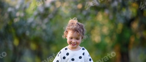 Preview: Front view of small girl walking outdoors in spring nature