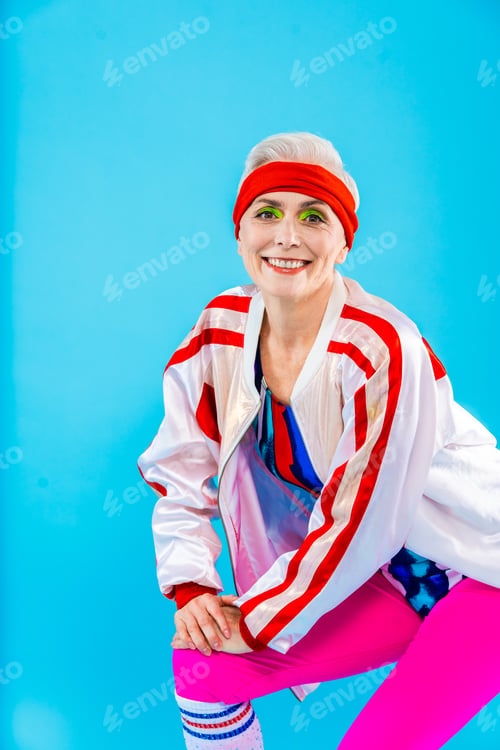 Preview: Happy and funny senior old woman on colorful background
