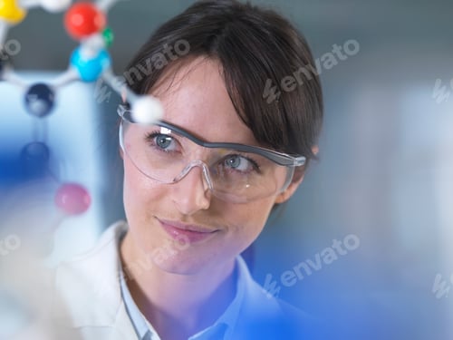 Preview: Scientist analysing molecular model in laboratory