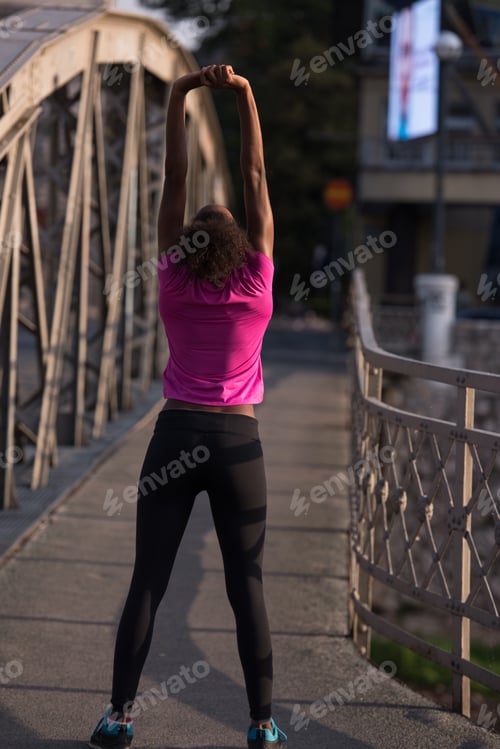 Preview: Black woman doing warming up and stretching