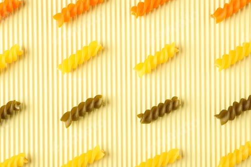 Preview: Flat lay composition with color pasta on light background, space for text and closeup