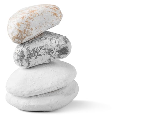 Preview: Stones stacked on top of each other placed on a plain background in a simple setting