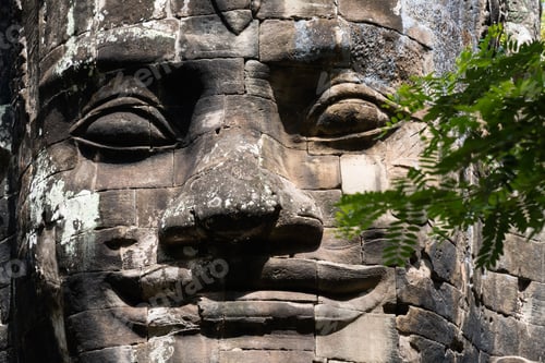 Preview: Closeup of huge head sculpture at the historic temple complex of Angkor Wat in Siem Reap, Cambodia