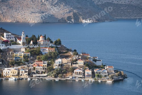 Preview: Picturesque view of Symi Island, Greece, featuring charming houses and a serene blue sea