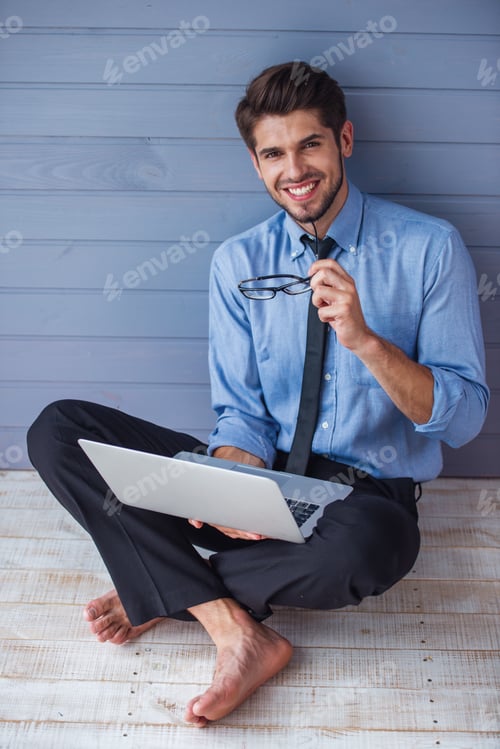 Preview: Handsome young businessman with gadget