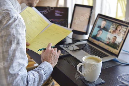 Preview: Virtual business meeting man multitasking signing contract documents at computer desk.