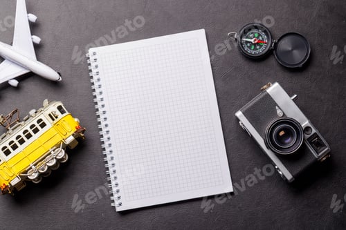 Preview: Creative flat lay of a travel-themed desk with notepad for plans