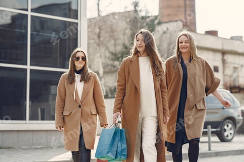 Preview: Woman walks outside with shopping bags