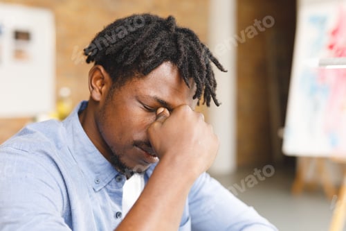 Preview: Tired african american male painter at work in art studio