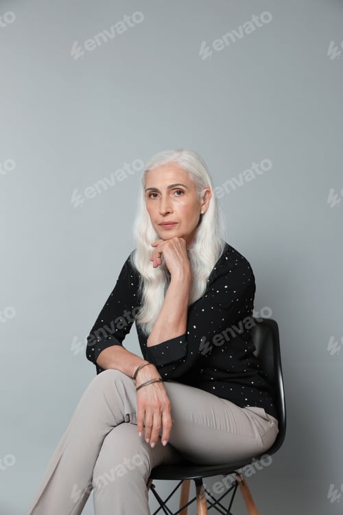 Preview: Portrait of beautiful mature woman on grey background