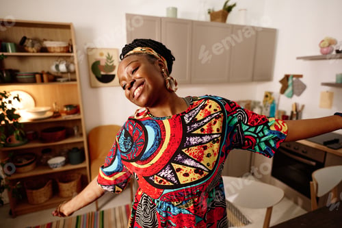 Preview: Young ecstatic woman in ethnic dress performing dance in front of camera