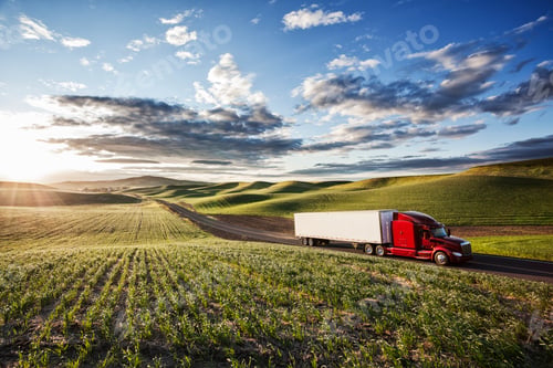Preview: Peterbilt Class8 commercial truck driving through farmlands in eastern Washsington, USA at sunset.