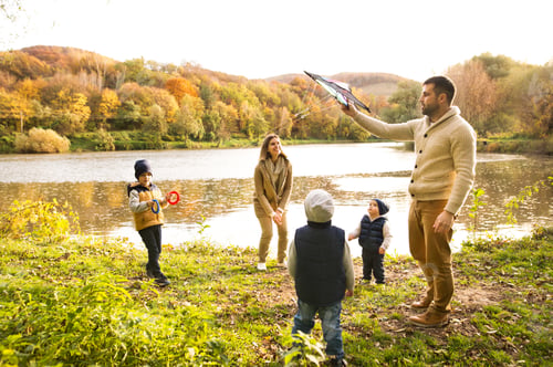 Preview: Beautiful young family on a walk in autumn forest.