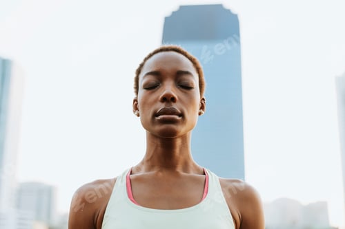 Preview: Woman meditating in the urban park