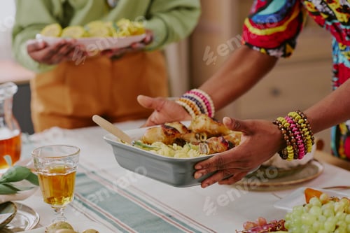Preview: Black Woman Serving Traditional Food during Kwanzaa Family Celebration