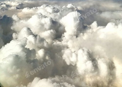 Preview: Aerial view above the clouds taken from a plane at 30,000 feet.