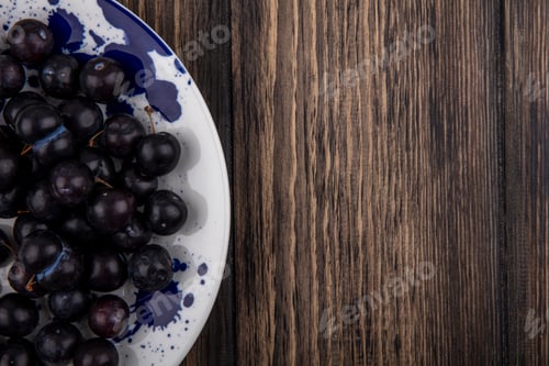 Preview: top view copy space cherry plum on white plate on wooden background