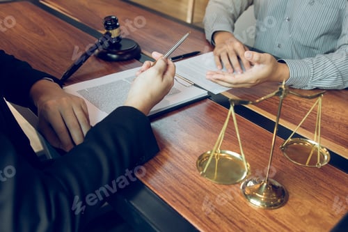 Preview: Legal advisor is explaining the offense under the law in the book at office.