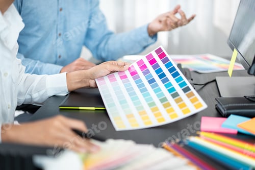 Preview: Two creative graphic designer team working on color selection and drawing on graphic tablet