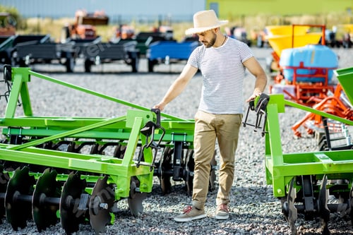 Preview: Agronomist at the shop ground with agricultural machinery