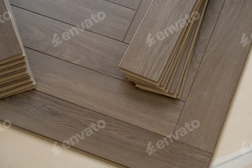 Preview: Worker installing laminate flooring in a residential apartment. Tools, planks