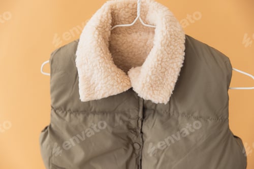 Preview: Sleeveless padded jacket with sheepskin lining hanging on hanger
