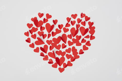 Preview: heart shaped arrangement of small red paper cut hearts isolated on white