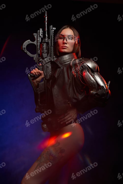 Preview: Seductive and martial woman poses with a rifle looking at camera