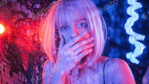 Preview: Shocked, scare look. Stylish woman with white hair is behind wet transparent plastic sheet