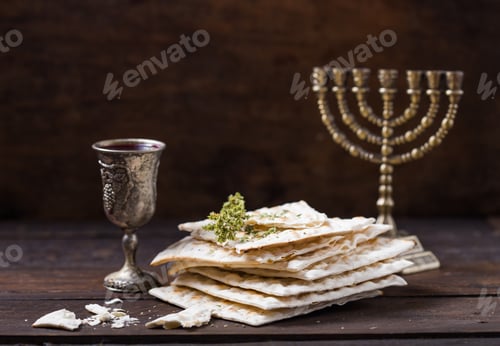 Preview: Red kosher wine with a white matzah or matza on a vintage wood background presented as a Passover