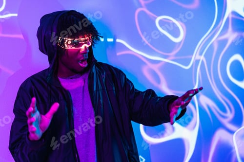 Preview: Shocked afro man using augmented reality goggles