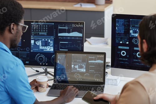 Preview: Focus on laptop with statistic graphic data on screen and IT manager