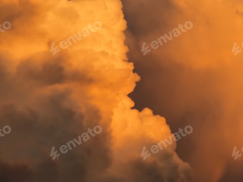 Preview: Fluffy clouds illuminated by the sunset