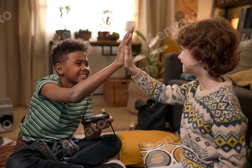 Preview: Two Friends Giving High Five Celebrating Video Game Win