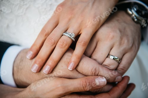 Preview: Close-up of an affectionate couple embracing, both wearing their engagement rings