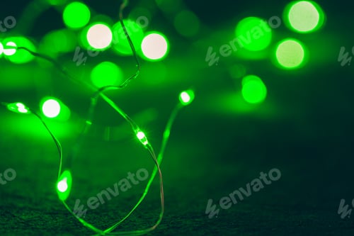 Preview: Bokeh of green garland lighting elements background