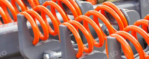 Preview: Hard orange spring made of steel. Part and detail of industrial or agricultural machine