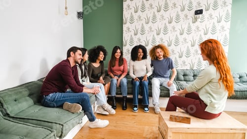 Preview: Happy diverse friends enjoying leisure time in living room at home