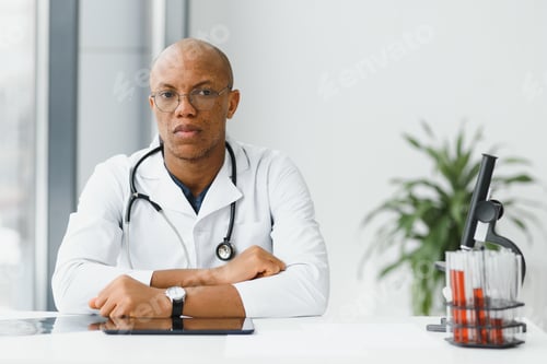 Preview: African American man male hospital doctor in white coat with stethoscope.