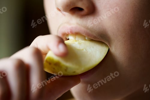 Preview: Crop unrecognizable young girl biting fresh juicy apple piece