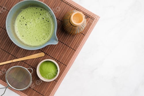 Preview: Traditional matcha kit, Bamboo whisk and beverage on bamboo mat in the kitchen