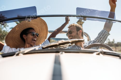 Preview: Multiracial couple in a convertible vintage car
