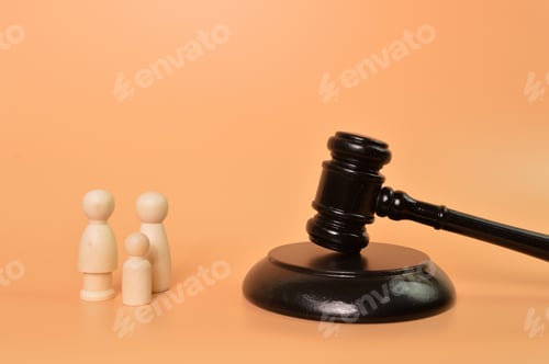 Preview: Family doll figures standing with judge gavel. Family law concept