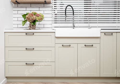 Preview: White kitchen furniture near the washbasin in white color in the style of milimalism.