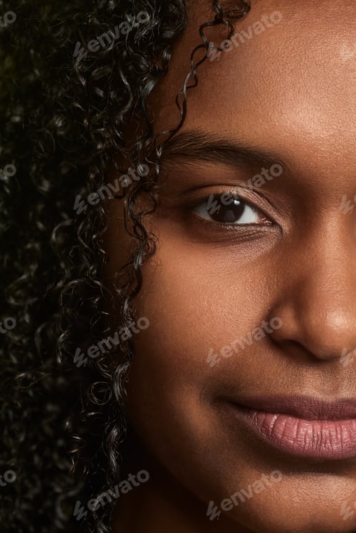 Preview: Half face of black curly haired woman