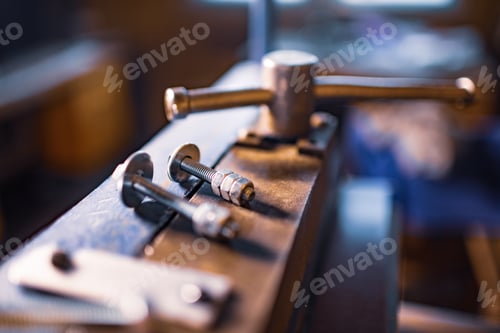 Preview: Metal chrome bolts and nuts on manual flexible massive machine